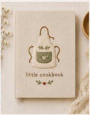 Hand embroidered recipe book featuring a minimalist cottagecore apron design on a linen hardcover notebook.