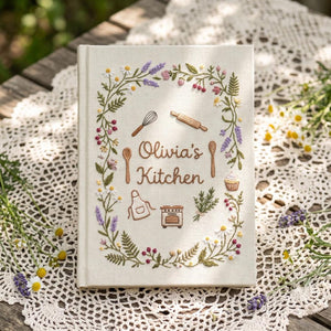 Personalized cottage kitchen hand embroidered recipe book featuring floral wreaths baking tools teapot bread cupcake and botanical embroidery