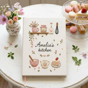Personalized hand embroidered recipe book featuring floral teapot whisk sugar jar mixing bowl strawberry cake and cottage tea party motifs