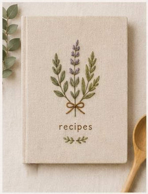 Hand embroidered recipe book featuring lavender herb bouquet embroidery tied with ribbon on linen hardcover cover