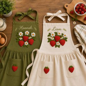 Personalized hand embroidered linen apron featuring strawberries, daisy flowers, botanical garden embroidery, and custom name personalization.