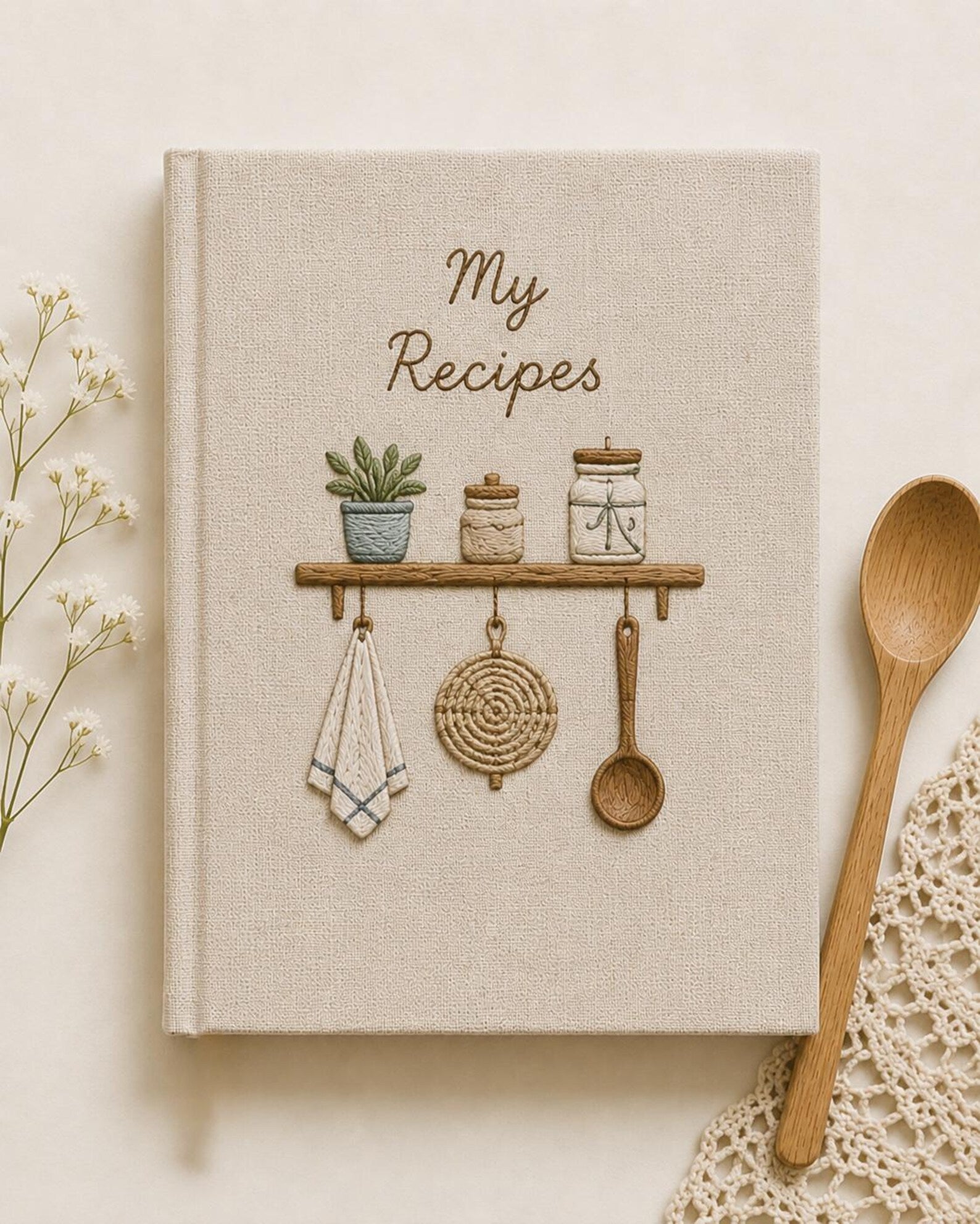 Hand embroidered recipe book featuring rustic pantry shelf with storage jars, botanical greenery, woven kitchen accents and cottage farmhouse decor.