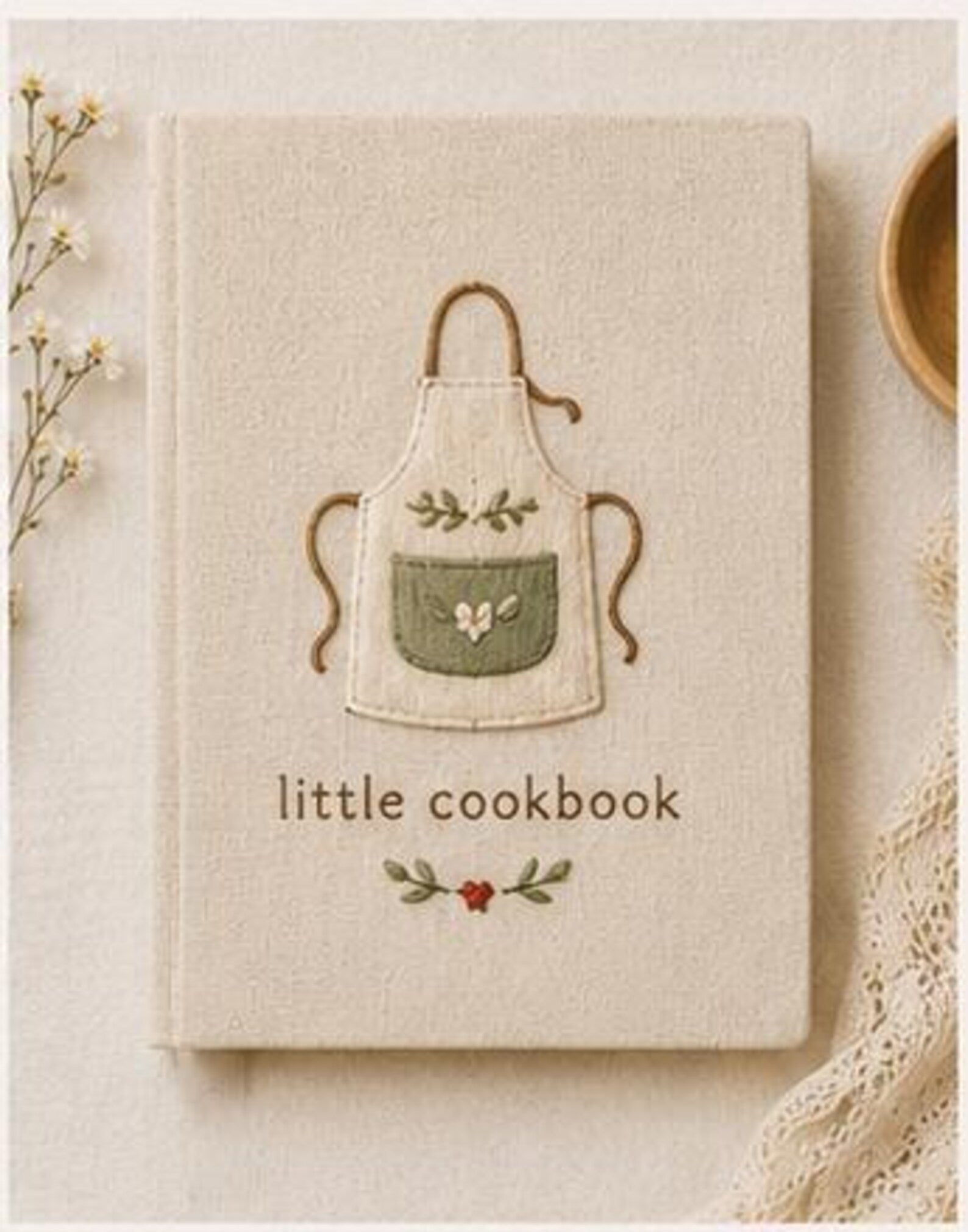 Hand embroidered recipe book featuring a minimalist cottagecore apron design on a linen hardcover notebook.