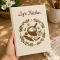 Personalized hand embroidered recipe book featuring rustic baking tools, daisy wreath, mixing bowl, rolling pin, butter dish and farmhouse kitchen design.