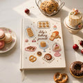 Personalized hand embroidered baking journal featuring cookies cakes donuts pastries macarons and bakery treats on linen cover