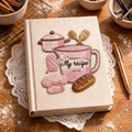 Personalized hand embroidered recipe book featuring pink baking tools, stand mixer, oven mitts, recipe cards, measuring cups, chef hat, whisk, and bakery-inspired embroidery on linen cover.