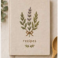 Hand embroidered recipe book featuring lavender herb bouquet embroidery tied with ribbon on linen hardcover cover
