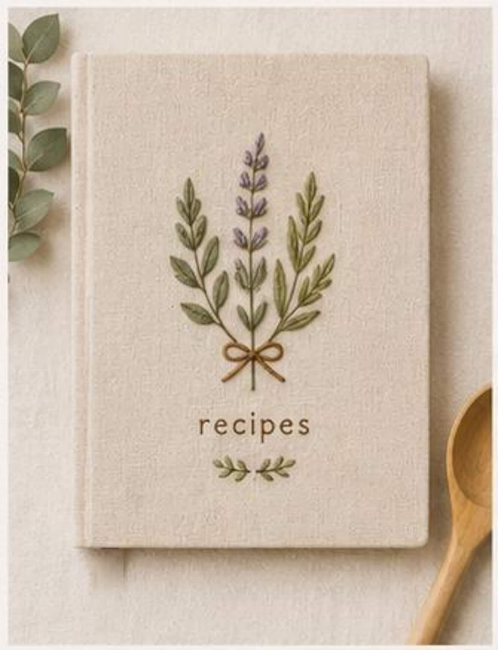 Hand embroidered recipe book featuring lavender herb bouquet embroidery tied with ribbon on linen hardcover cover
