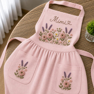 Personalized hand embroidered apron featuring lavender flowers, cottage garden blooms, botanical embroidery, and custom name on natural linen fabric.