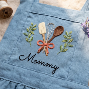 Personalized hand embroidered linen apron featuring baking tools embroidery with custom name, designed for kids who love baking, cooking, and creative kitchen activities.