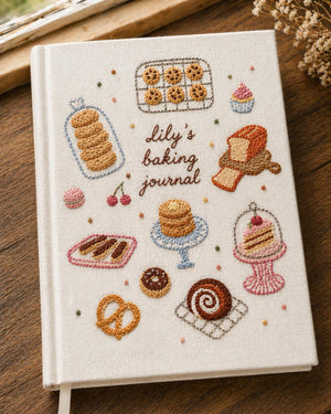 Personalized hand embroidered baking journal featuring cookies cakes donuts pastries macarons and bakery treats on linen cover