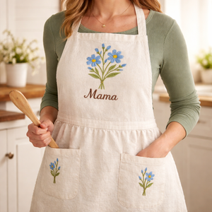 Personalized hand embroidered apron featuring blue wildflower embroidery and custom name on natural linen apron.