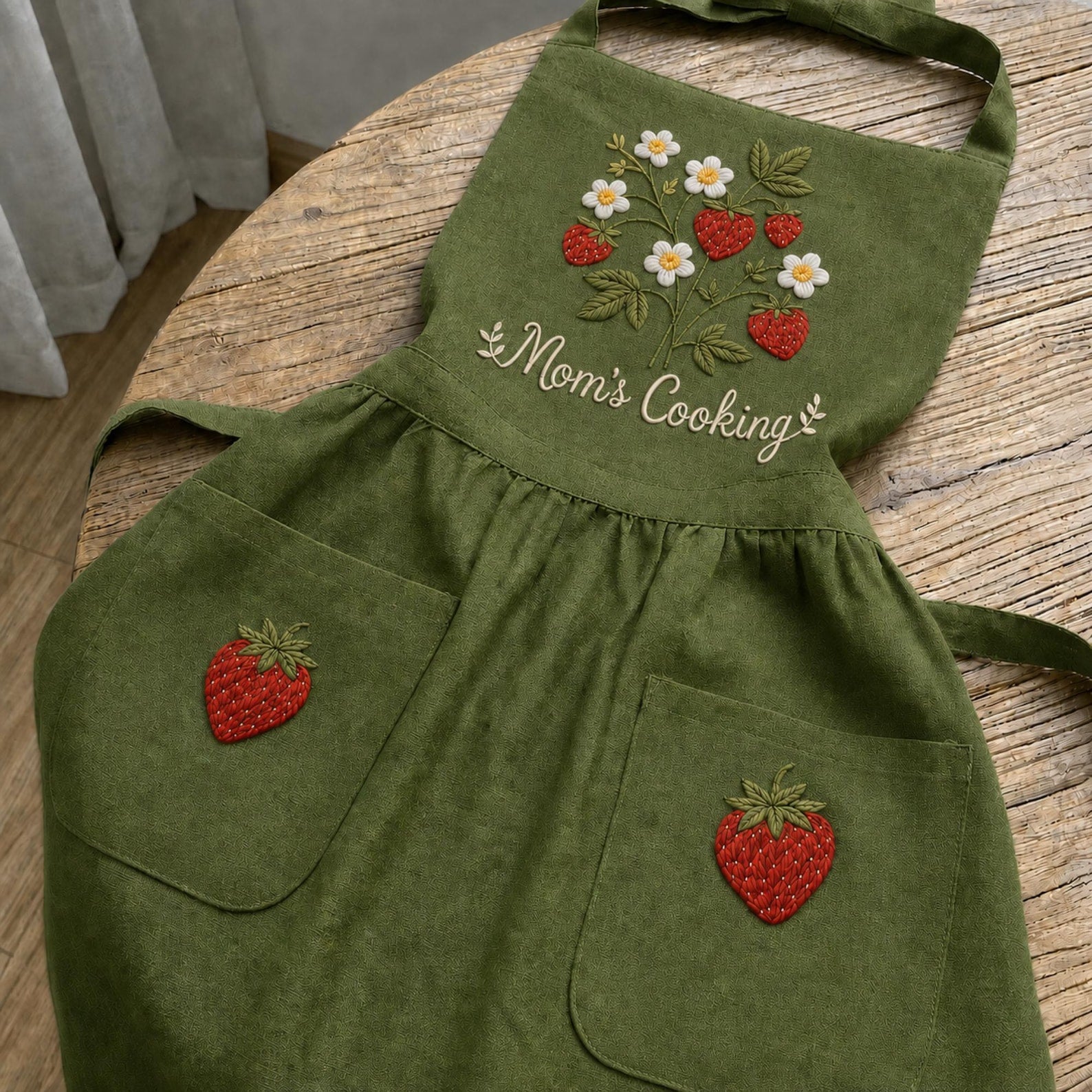 Personalized hand embroidered strawberry garden linen apron featuring strawberries, white flowers, botanical vines and custom text, cottagecore kitchen apron gift.