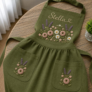 Personalized hand embroidered apron featuring lavender flowers, cottage garden blooms, botanical embroidery, and custom name on natural linen fabric.