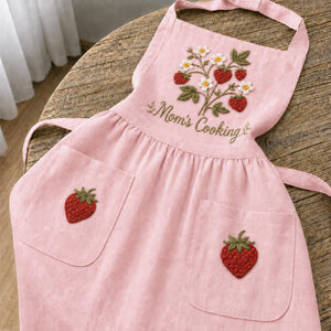 Personalized hand embroidered strawberry garden linen apron featuring strawberries, white flowers, botanical vines and custom text, cottagecore kitchen apron gift.