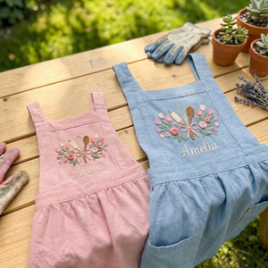 Personalized hand embroidered linen baker apron featuring floral baking utensils embroidery and custom name personalization on a natural beige apron.
