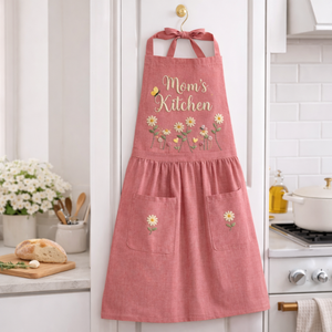 Personalized hand embroidered apron featuring bees, wildflowers, daisy flowers, and custom name embroidery on pink linen fabric.