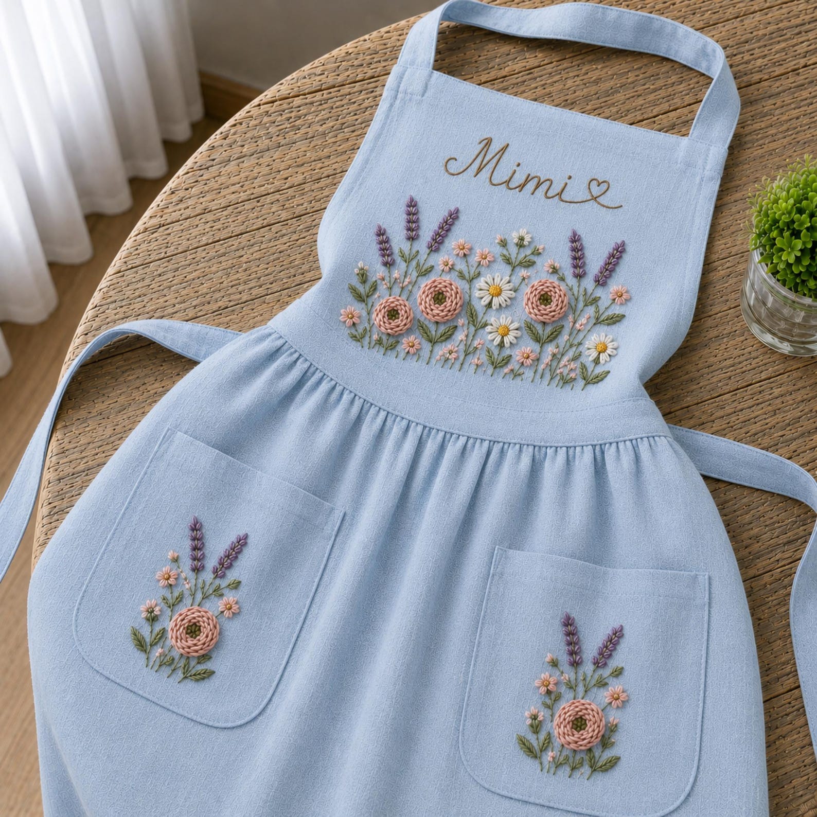 Personalized hand embroidered apron featuring lavender flowers, cottage garden blooms, botanical embroidery, and custom name on natural linen fabric.