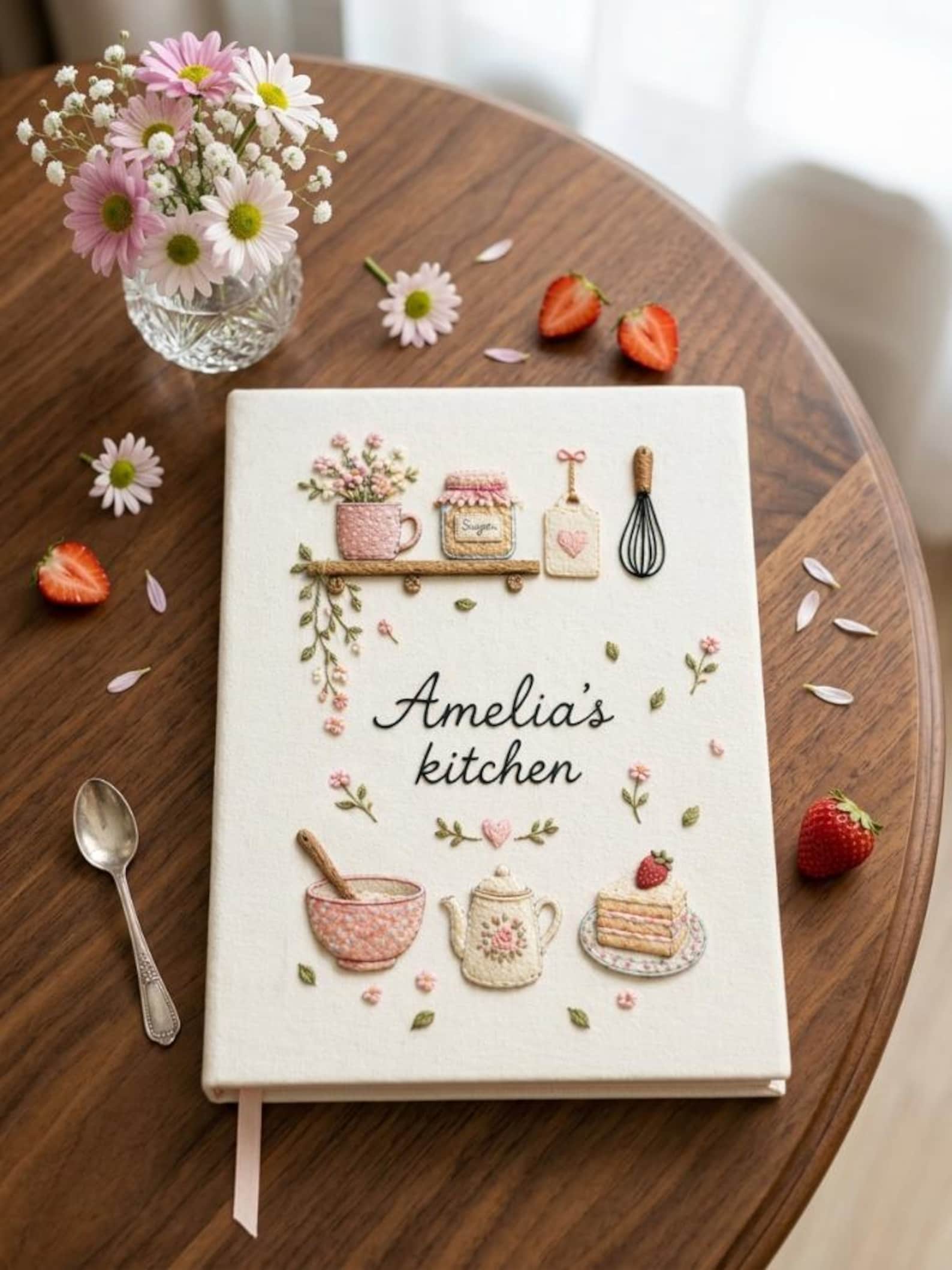 Personalized hand embroidered recipe book featuring floral teapot whisk sugar jar mixing bowl strawberry cake and cottage tea party motifs