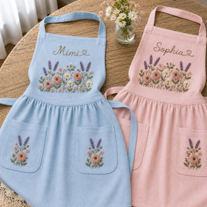 Personalized hand embroidered apron featuring lavender flowers, cottage garden blooms, botanical embroidery, and custom name on natural linen fabric.